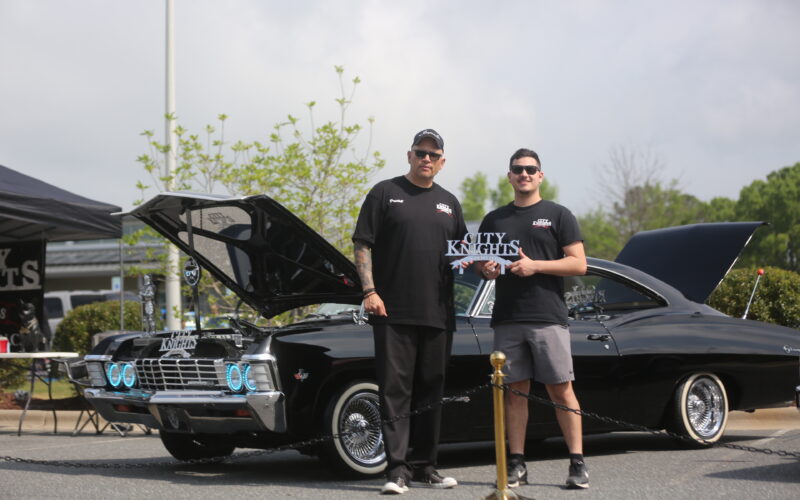 Daniel Castañeda, president of the City Knights Lowriders Car Club in Fayetteville, and his son Daniel stand in front of their 1967 Chevy Impala at the Lowrider Show, Saturday in Pittsboro. Ena Sellers / North State Journal