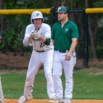 Pinecrest’s Connor Tepatti celebrates at first base after setting the school’s single-season hits record in the Patriots’ playoff opener, a win over Green Hope. David Sinclair