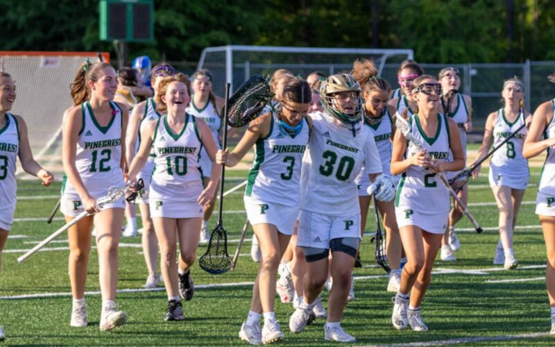 Audrey Kilgore (3), Sam Lineback (30) and the rest of Pinecrest’s girls’ lacrosse team leaves the field after a 12-11 win over Laney to advance in the playoffs. David Sinclair