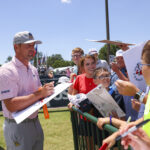 Bryson DeChambeau signs autographs for fans outside the practice green at the 2024 U.S. Open at Pinehurst. (Matt Hahn/USGA)