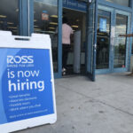 A "Now Hiring" sign sits outside a Ross Dress for Less store in Florida in a file photo from 2020. Wilfredo Lee / AP Photo