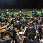 Pinecrest’s football team huddles up after a 27-7 scrimmage win over Apex at last Friday’s Moore County Jamboree. The games start for real across the county, this Friday night. (David Sinclair for the North State Journal)