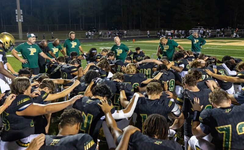 Pinecrest’s football team huddles up after a 27-7 scrimmage win over Apex at last Friday’s Moore County Jamboree. The games start for real across the county, this Friday night. (David Sinclair for the North State Journal)