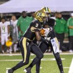 Pinecrest running back Zymire Spencer gets the handoff in a game against Richmond earlier this season. Spencer had a big game on Friday as the Patriots got back in the win column. (David Sinclair for North State Journal)