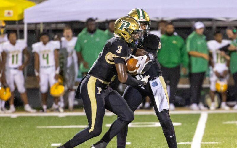 Pinecrest running back Zymire Spencer gets the handoff in a game against Richmond earlier this season. Spencer had a big game on Friday as the Patriots got back in the win column. (David Sinclair for North State Journal)